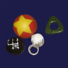 three different types of beads on a dark blue background, one with a yellow star and one with a green triangle