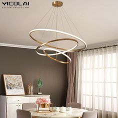 a dining room table with chairs and a chandelier hanging from it's ceiling