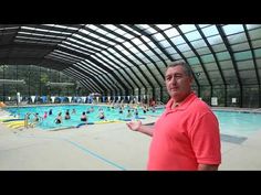 a man standing in front of a swimming pool