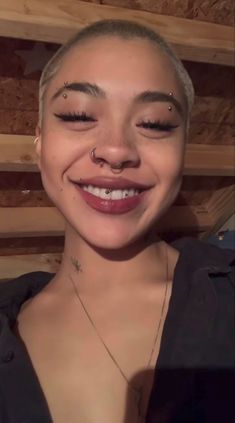 a smiling woman with piercings on her nose