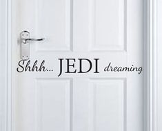 a white door with the words shh sith dreaming written in black on it