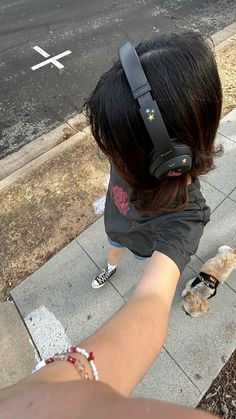 a person with headphones on walking down the street