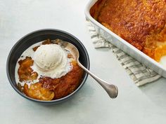 a bowl of ice cream next to a casserole dish on a white table