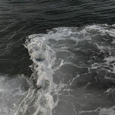 a person riding a surfboard on top of a large body of water in the ocean