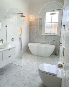 a bathroom with a tub, sink and mirror