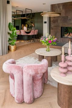 a living room filled with furniture and a fire place next to a dining room table