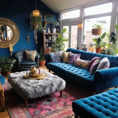 a living room filled with blue couches and lots of potted plants on top of them