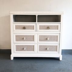 a white dresser with several drawers on it