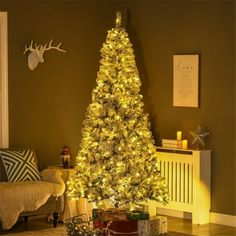 a christmas tree is lit up in the living room with presents on the floor next to it