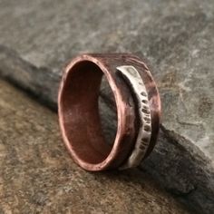 I cold-forged and distressed each band from pure, solid copper. I add a rustic, textured Sterling silver accent for contrast and interest. Each ring I create is hammered and textured with primitive techniques to achieve an organic and truly rustic form. The inside and edges are polished smooth for an extremely comfortable fit. SIZING & FINISH: SIZE: Custom - choose at checkout WIDTH: approx 8.5-9mm FINISH: pure, organic copper (oxidized) with .925 Sterling accents The ring in the photos has Rust Colored Hammered Copper Jewelry, Rustic Brown Hammered Jewelry, Rustic Hand Forged Ring Jewelry, Rustic Hammered Jewelry For Anniversary, Rustic Hammered Bronze Jewelry, Rustic Rust Jewelry With Patina, Rustic Hand Cast Adjustable Jewelry, Rustic Adjustable Hand Cast Jewelry, Rustic Hand Forged Bronze Jewelry