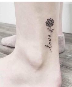 a small sunflower tattoo on the ankle that reads,'i love you '