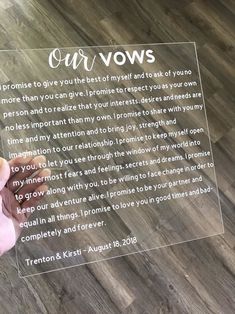 someone is holding up a clear glass plaque with the words our vows written on it