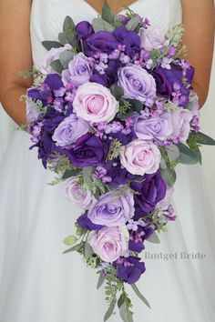 a bridal holding a bouquet of purple flowers