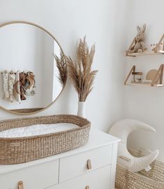 a baby crib in front of a round mirror