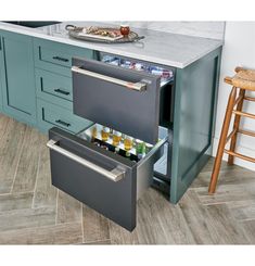 an open drawer in the middle of a kitchen