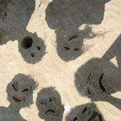 several people are standing in the sand with their footprints