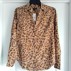 Nwt Women's Ann Taylor Top Size: Extra-Small (Xs) Color: Tan Background With Allover Small-Scale Brown Abstract Leopard Print Collared V-Neck With 5-Button Placket Long Sleeves Single Button Cuffs Angled Side Darts At Chest Straight Yoke In Back Rounded Hem Lightweight Sateen Fabric With Low Sheen Chest 36" (18" From Left To Right Seam) Sleeves 23.5" Overall Length 27" To Lowest Point Of Hem 100% Polyester Machine Washable Or Dry Clean Pristine Unworn Condition Leopard Print Button-up Top For Work, Abstract Leopard, Tan Background, Leopard Animal, Button Down Blouse, Button Placket, Ann Taylor, New Color, Leopard Print