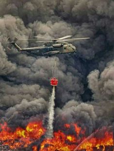 a helicopter dropping water from a fire in the sky