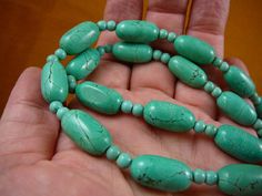 "(Internal #V-462-7) You are bidding on a beautiful, handmade necklace made with paua shell on Chinese turquoise oblong beads 10x21 mm, spacer beads 4 mm; necklace is 21\" long; gold safety closure. This is a lovely necklace! ABALONE (Paua) shell necklaces - Paua shell pendant is green iridescent coloring, polished, full shell (reversible) Pendant size average: 2\" long x 1-1/2\" wide x 1/2\" thick; Cap is glued to shell, and loop wired through it to the necklace. On a gem necklace as described. Paua Shell Necklace, Spartanburg Sc, Iridescent Green, Paua Shell, Gem Necklace, Lovely Necklace, Shell Pendant, Shell Necklaces, Handmade Necklace