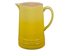 a yellow pitcher sitting on top of a white table