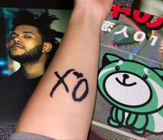 a person with a small tattoo on their arm and the word xo written in black ink