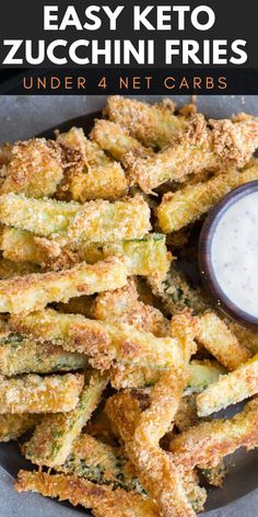 fried zucchini fries on a plate with ranch dressing in the background and text overlay that reads easy keto zucchini fries