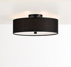 a black lamp hanging from the ceiling in a room