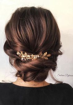 a woman is wearing a gold hair comb