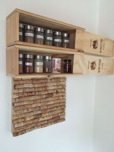 two wooden shelves holding jars and spices on top of each other in front of a white wall