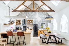 a kitchen with an island and bar stools