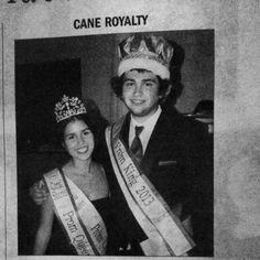 a black and white photo of a man and woman wearing crowns, standing next to each other