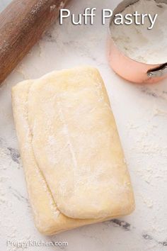 homemade puff pastry on a counter with rolling pin