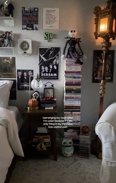 a bed room with two beds covered in white sheets and pictures on the wall above them