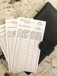 three receipts sitting on top of a black wallet