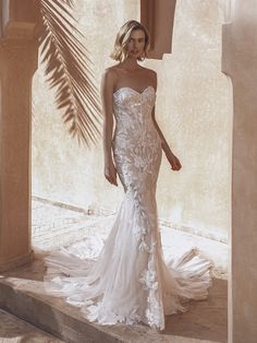 a woman in a wedding dress standing on steps