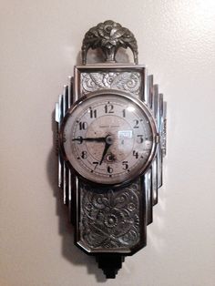 an antique clock is hanging on the wall