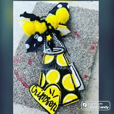 a yellow and black bow with polka dots on it sitting on top of a rock