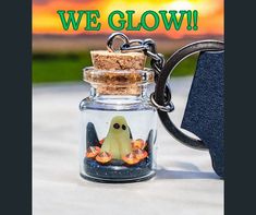 there is a glass jar with a ghost in it and the words, we glow