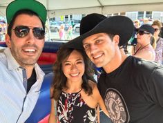 two men and a woman are posing for a photo in an inflatable tent