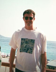 a man standing next to a woman near the ocean