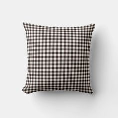 a black and white checkered pillow on a wall