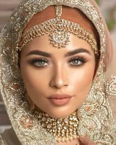 a woman wearing a bridal veil and jewelry