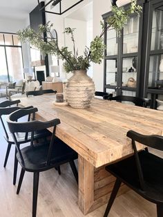 a large wooden table with black chairs around it