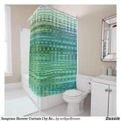 a bathroom with a green shower curtain next to a toilet