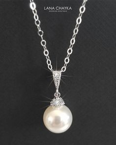 Wedding Swarovski 10mm White Pearl Drop 925 Sterling Silver Chain CZ Bridal Necklace. CHAIN is 18 inches (45.7 cm) long. PENDANT is about 1 inch (2.4 cm) long including bail. MATCHING EARRINGS: https://www.etsy.com/listing/95683858/white-pearl-drop-bridal-earrings?ref=shop_home_active_2 This necklace is made with 925 Sterling Silver chain, Swarovski 10mm White round crystal pearl, Rhodium Sterling Silver pearl component with clear Cubic Zirconia stones, and silver (Original Rhodium) plated bail Classic White Gold Necklace For Wedding, Classic White Gold Bridal Necklace For Wedding, Classic Wedding Necklace With Round Pendant, Classic Pearl White Bridal Necklace For Wedding, Sterling Silver Pearl Chain Jewelry For Wedding, Classic Round Pendant Necklace For Wedding, Classic Bridal Necklace With Pearl Pendant For Wedding, Sterling Silver Wedding Necklace, Classic Pearl Chain Jewelry For Weddings