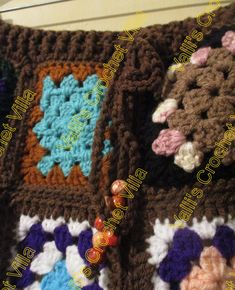 a crocheted blanket is laying on top of a bed with buttons and beads