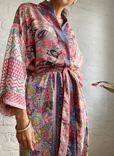 "This is one of a kind patchwork, upcycled silk robe Made free size with wrap tie closing and wide kimono sleeves  Easy and fun to wear around the house or outside as a urban boho style,  flowy kardigan with jeans and tshirt  It is very comfy and feels soft and light  the material is colorful and flowy  made into this unique stylish over all MEAESURE free size length 55\" MATERIAL *polyester  *no lining CARE INSTRUCTIONS  * Wash in warm water * Hand wash recommended * Hang to dry Please visit al Pink Bohemian Robe With Kimono Sleeves, Multicolor Wrap Robe For Loungewear, Bohemian Pink Robe With Kimono Sleeves, Pink Long Sleeve Kimono With Patchwork, Kaftan Dress Boho, Festive Floor-length Bohemian Kimono, Multicolor Patchwork Robe With Kimono Sleeves, Festive Bohemian Floor-length Kimono, Bohemian Long Tie-dye Kimono