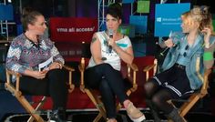 three women sitting in chairs with microphones on their heads and talking to each other