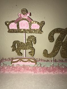 a pink and gold cake with a princess crown on top