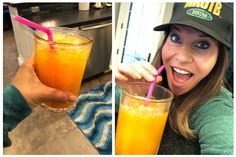 a woman is holding up a glass of orange juice and smiling at the camera while wearing a hat